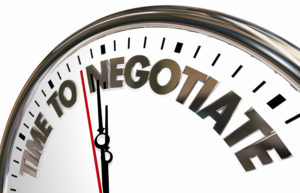 Image of clock with the words "Time To Negotiate" in place of numbers.