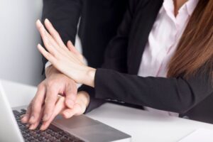 female hands on keyboard pushing male away